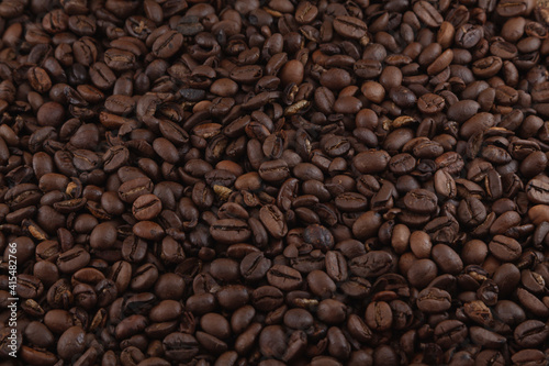 Many coffee beans in dimly lit environment