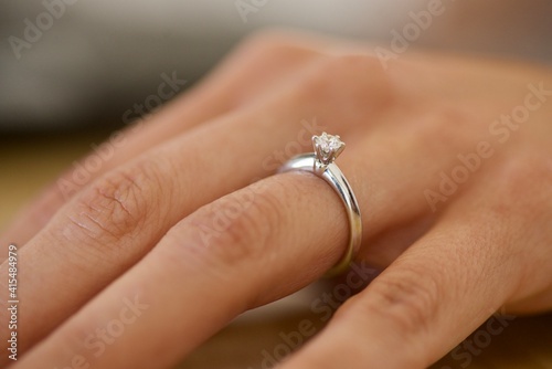 Woman hand wearing an engagement ring