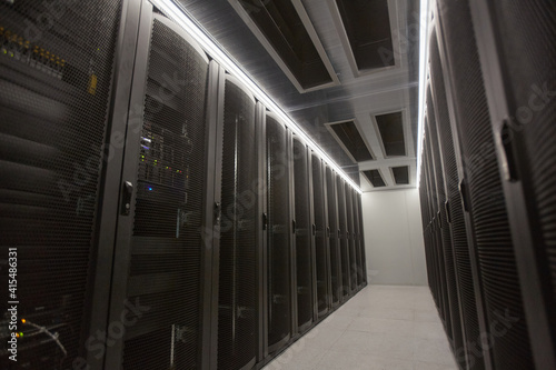 Wide angle background image of server room hall with supercomputer in data center or research facility, copy space