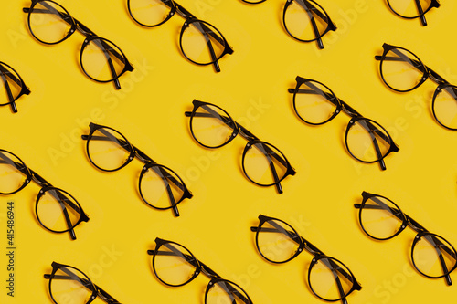 Photo of repeating glasses pattern. Visual concept of hipster or cinema glasses that can be used as a promo background for text copy