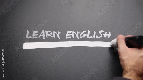 Man highlighting on a blackboard with text 