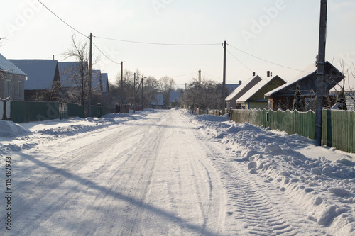 Winter rural road and trees in snow in Belarus