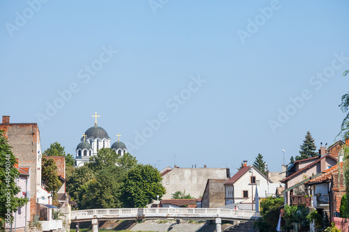 Typical panorama of the pedestrian city center of Valjevo, Serbia, with the Kolubara river, some cafes and restaurants and Valjevo temple church, Saborna Crva, or hram vaskrsenja hristovog