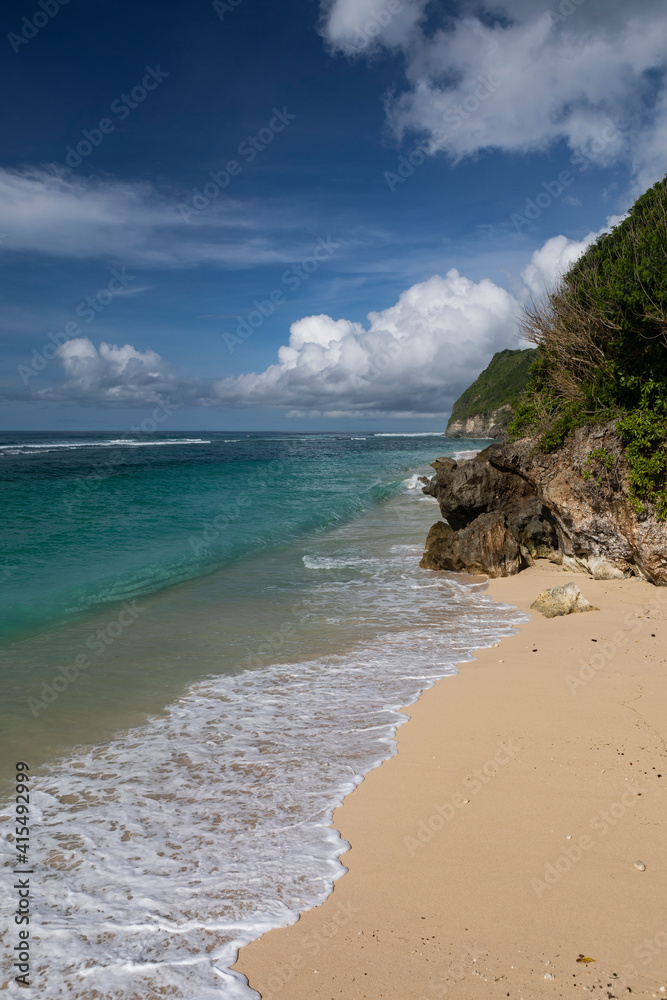 Crystal clear water of a lagoon with waves breaking along a white sand beach in Bali in Indonesia, located on the southern coast of the island. Crystal clear water of a lagoon with waves breaking along a white sand beach in Bali in Indonesia, located on the southern coast of the island.