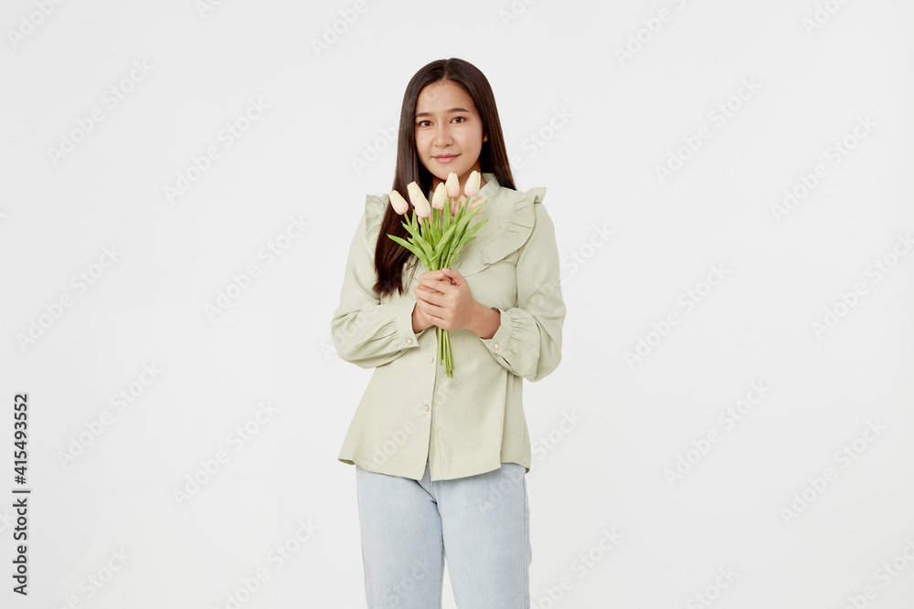 Spring Beautiful cheerful girl smiling and holding a bouquet of tulip flowers. Young happy woman. Surprise at the 8 March International Women's Day. Spring Beautiful cheerful girl smiling and holding a bouquet of tulip flowers. Young happy woman. Surprise at the 8 March International Women's Day.