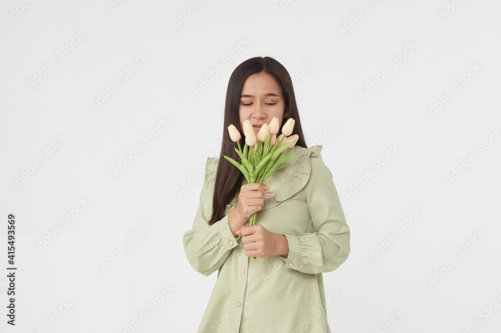 Spring Beautiful cheerful girl smiling and holding a bouquet of tulip flowers. Young happy woman. Surprise at the 8 March International Women's Day. Spring Beautiful cheerful girl smiling and holding a bouquet of tulip flowers. Young happy woman. Surprise at the 8 March International Women's Day.