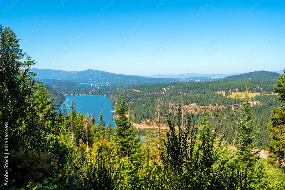 View of Fernan Lake and Lake Coeur d'Alene including the downtown skyline in the mountains of Coeur d'Alene, Idaho USA