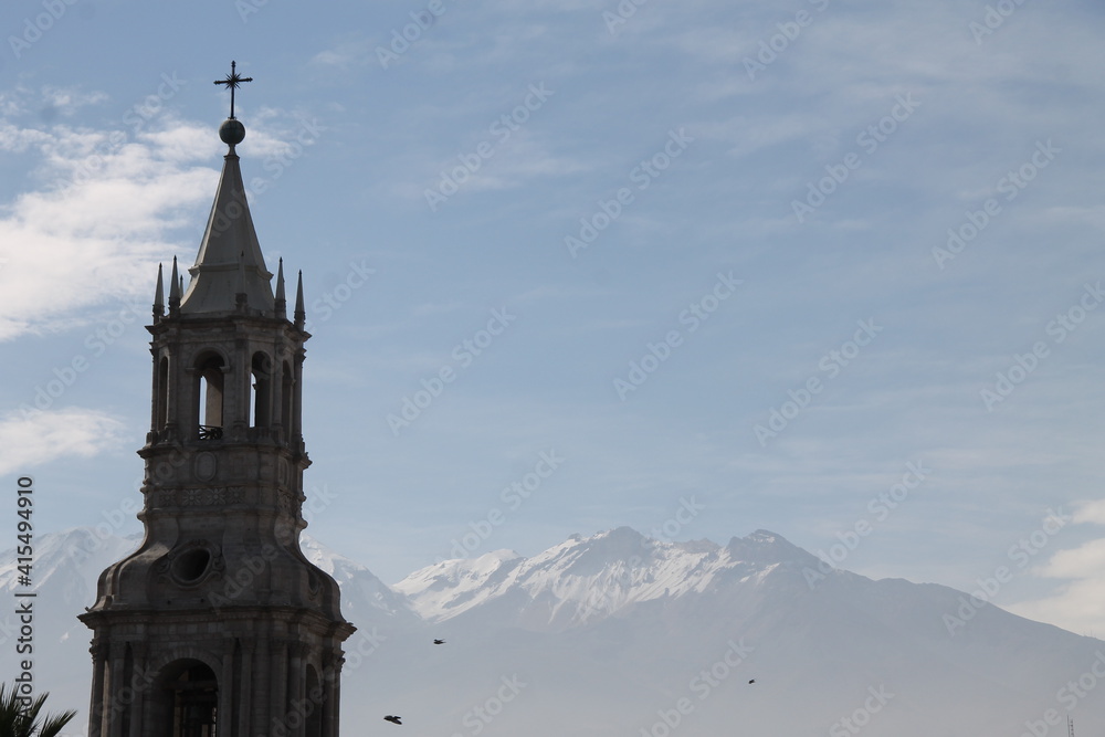 Church with snow-capped mountain in the background.