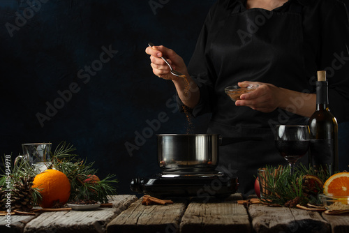 preparing mulled wine, in the kitchen on the background of ingredients