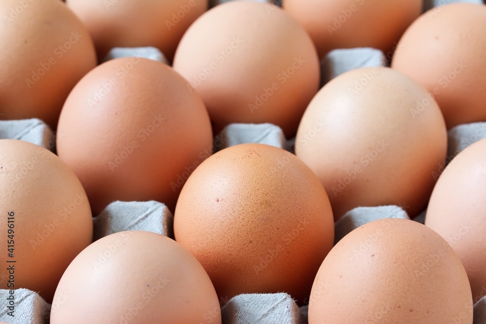 A close up shot of some fresh farm eggs on a cardboard egg tray.