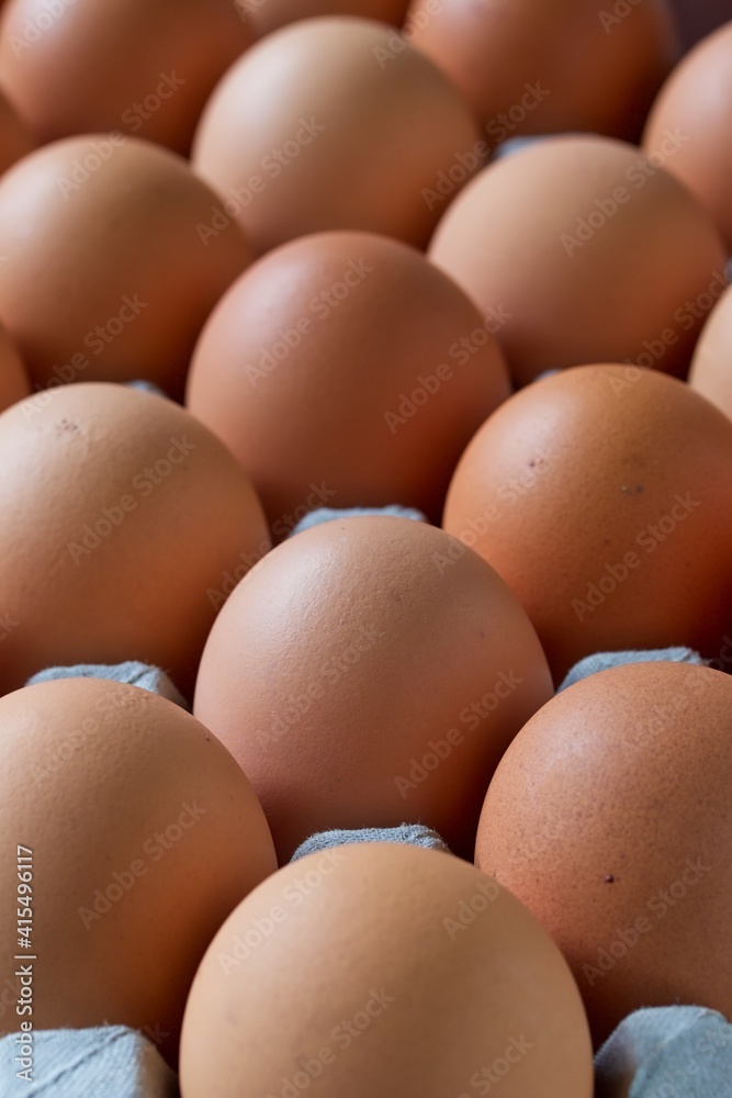 A close up shot of some fresh farm eggs on a cardboard egg tray. A close up shot of some fresh farm eggs on a cardboard egg tray.