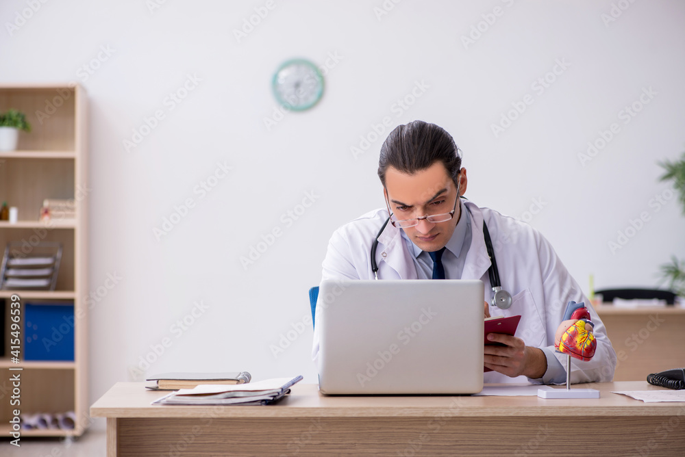 Young male doctor lecturer cardiologist working in the clinic Young male doctor lecturer cardiologist working in the clinic