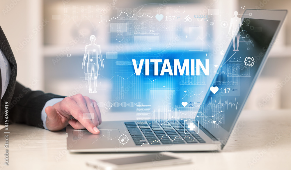 Doctor working a health check with VITAMIN inscription, recording medical test results Doctor working a health check with VITAMIN inscription, recording medical test results