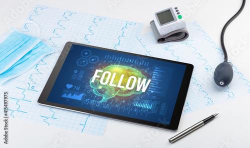 Tablet pc and medical tools with FOLLOW inscription, social distancing concept