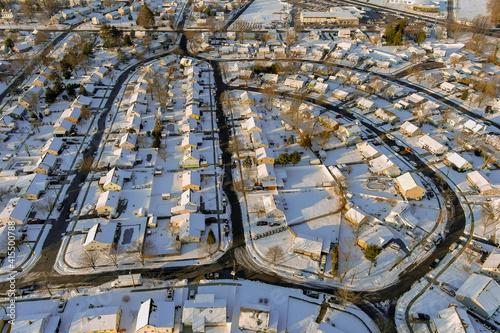 Fototapeta Naklejka Na Ścianę i Meble -  Snowy winter on the residential streets after the snow of a small town