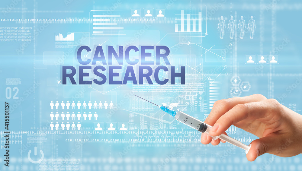 Close-up view of doctor's hand in a white glove holding syringe with CANCER RESEARCH inscription, healthcare and medical concept Close-up view of doctor's hand in a white glove holding syringe with CANCER RESEARCH inscription, healthcare and medical concept