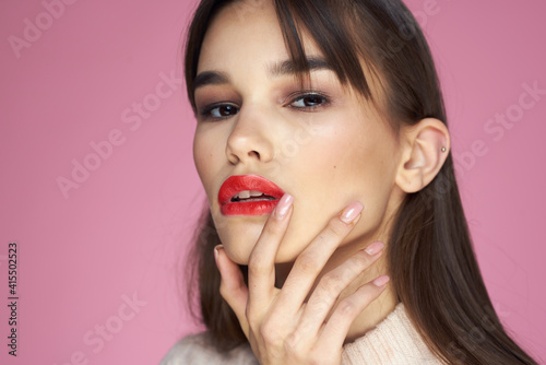 Beautiful brunette red lips white blouse close-up attractive view pink background