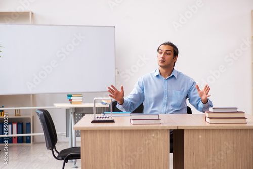 Young male teacher in the classroom