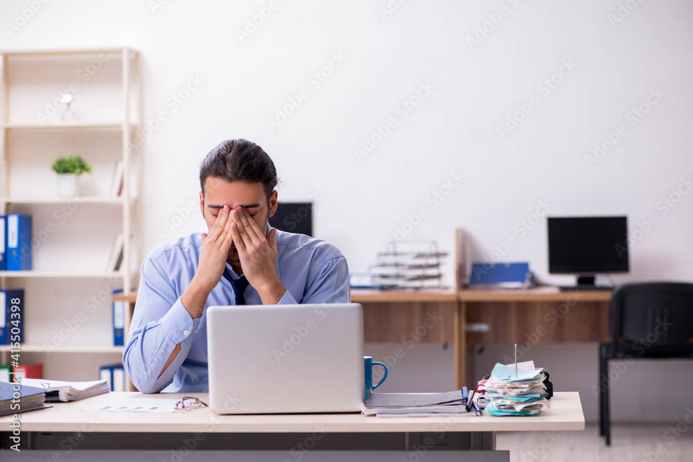 Sick male employee suffering at workplace Sick male employee suffering at workplace