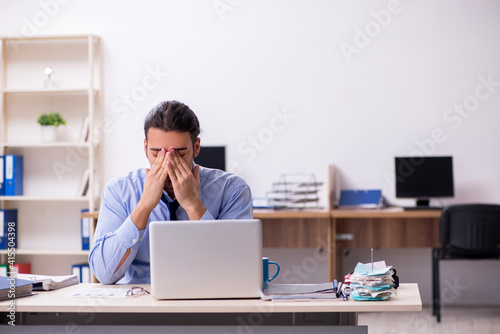 Sick male employee suffering at workplace