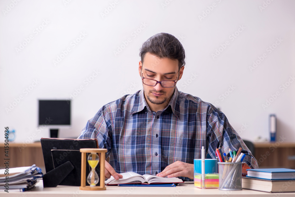 Young male student sitting in the classroom