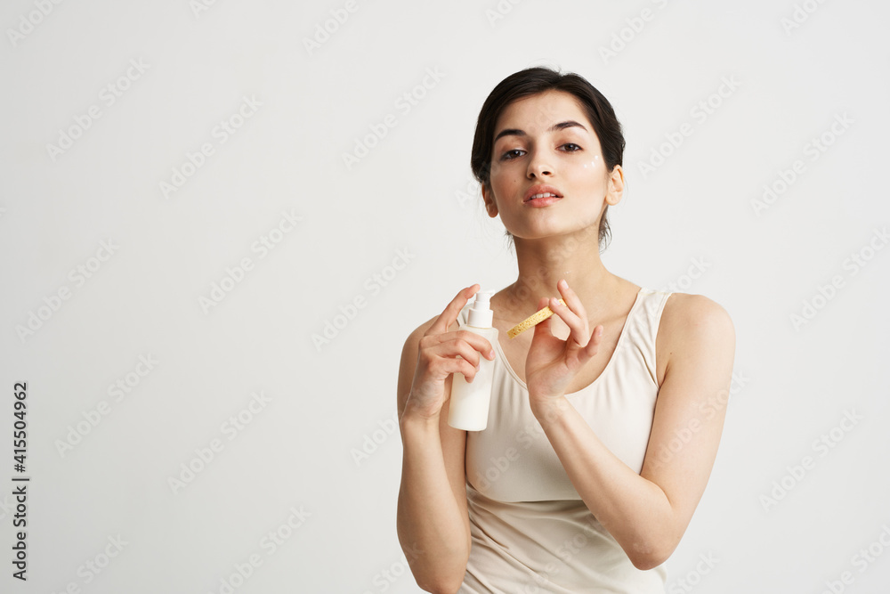woman in white t-shirt Sponge with cream clean skin health cosmetics