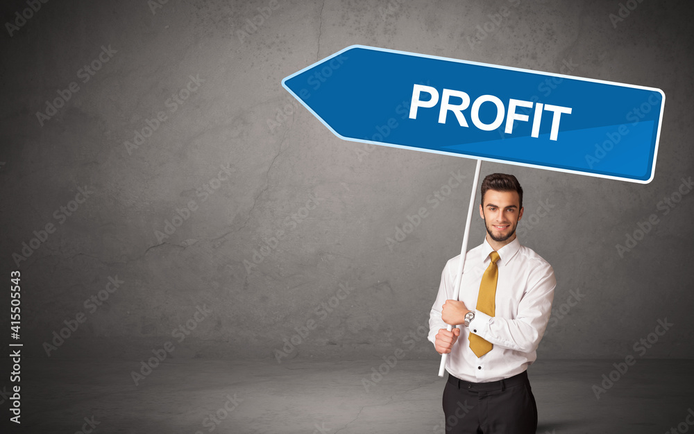 Young business person in casual holding road sign with PROFIT inscription, new business direction concept Young business person in casual holding road sign with PROFIT inscription, new business direction concept