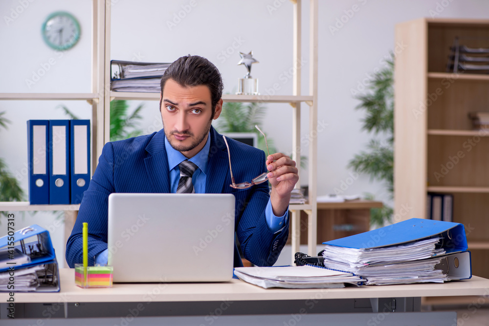 © Elnur - Young businessman employee unhappy with excessive work