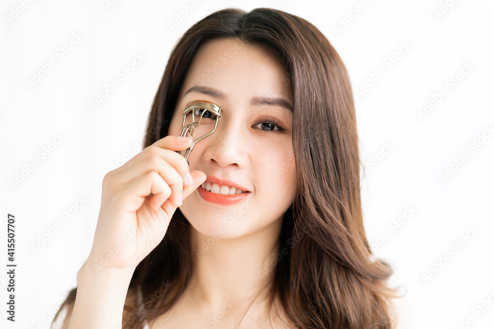 Asian woman sitting makeup in front of mirror Asian woman sitting makeup in front of mirror