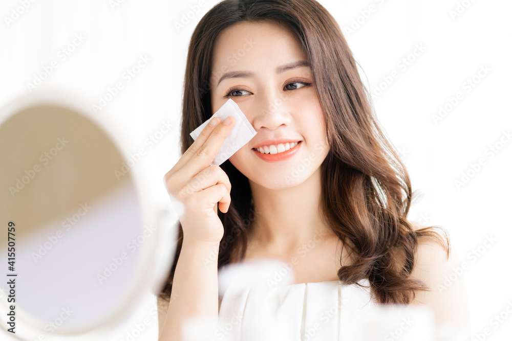 Asian woman sitting makeup in front of mirror Asian woman sitting makeup in front of mirror