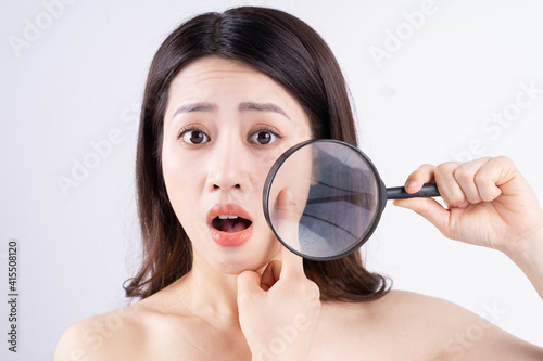 Asian woman with a surprised expression when appearing acne photo