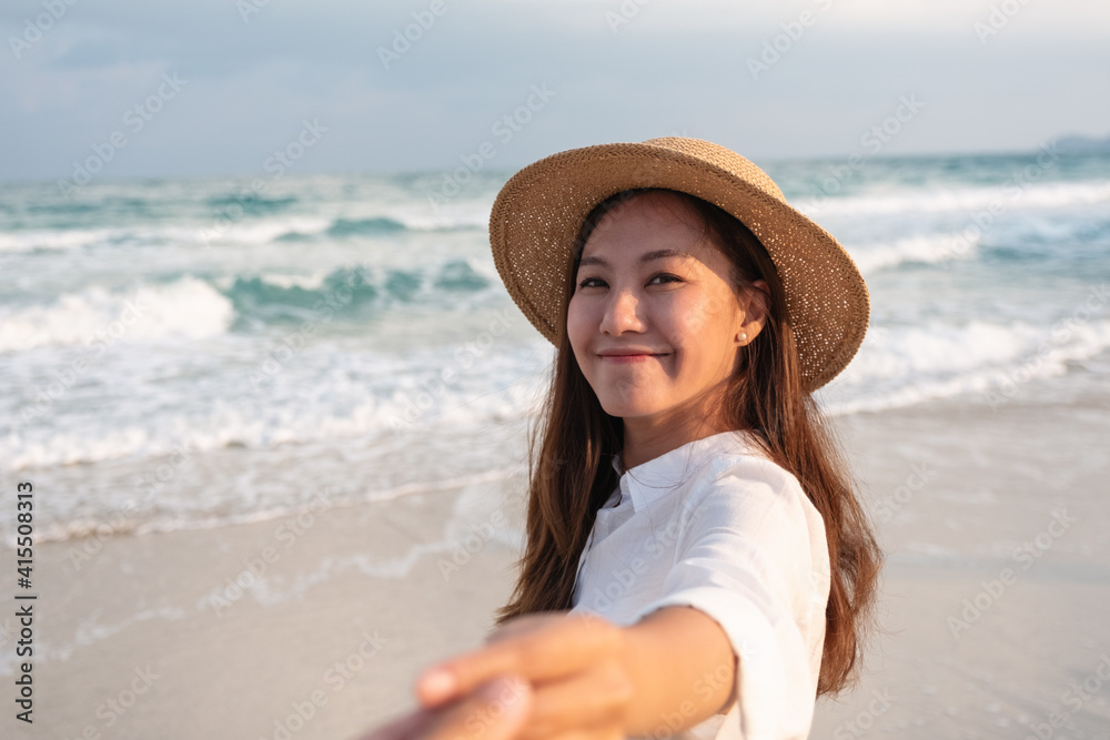 custom made wallpaper toronto digitalA beautiful young asian woman holding hand and leading her boyfriend to the beach for follow me concept