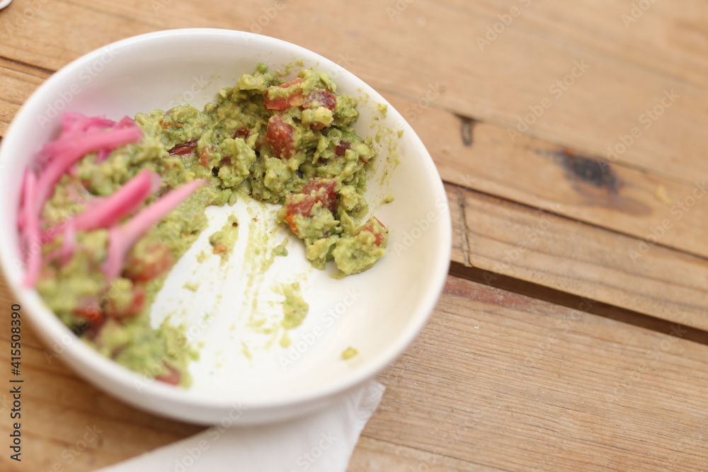 Bowl of guacamole with fresh ingredients Bowl of guacamole with fresh ingredients