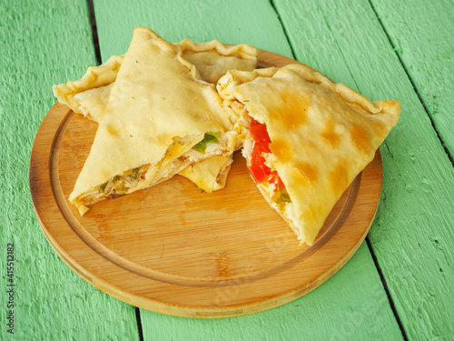 pie with tomatoes on a green wooden background