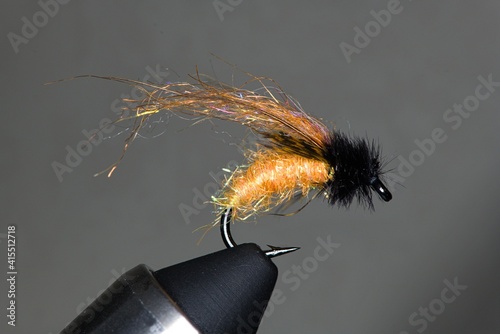 orange caddis fly tied on curved hook photo