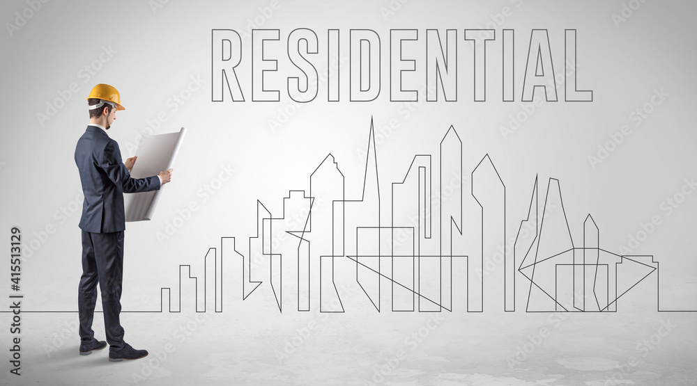 Businessman in hard hat holding blueprint with RESIDENTIAL inscription, engineering and architecture concept Businessman in hard hat holding blueprint with RESIDENTIAL inscription, engineering and architecture concept