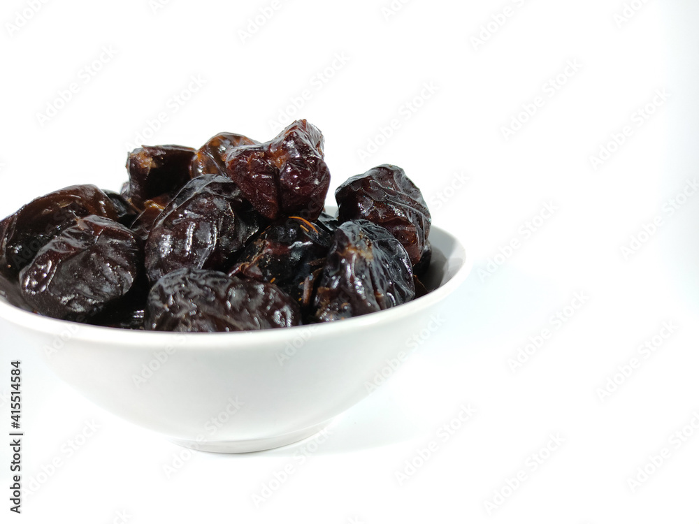 Selective focus.Dried sweet dates on bowl isolated on white background. Healthy food concept. Selective focus.Dried sweet dates on bowl isolated on white background. Healthy food concept.