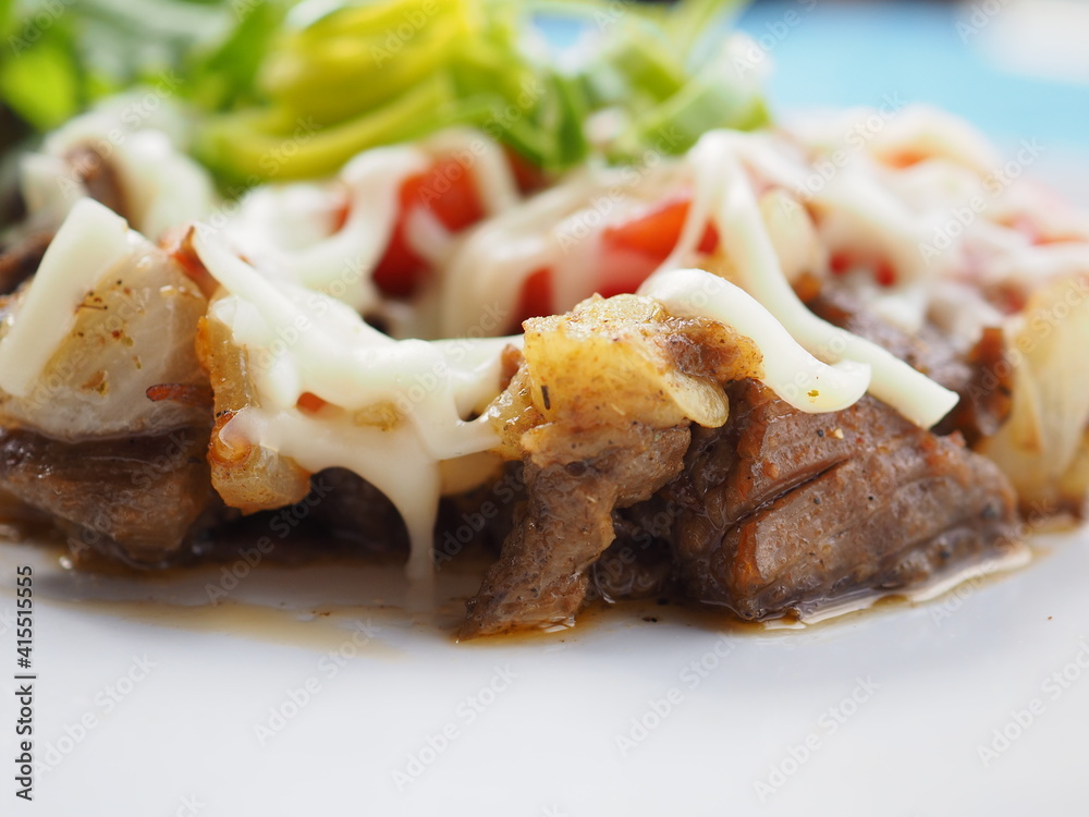 Meat salad on blue wooden background Meat salad on blue wooden background