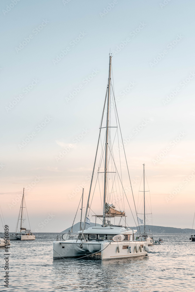 Catamaran float on Adriatic sea near Komiza Vis Island in Croatia sunset summer