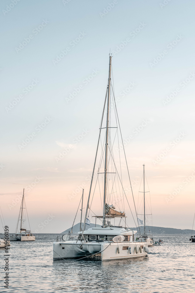 Catamaran float on Adriatic sea near Komiza Vis Island in Croatia sunset summer Catamaran float on Adriatic sea near Komiza Vis Island in Croatia sunset summer