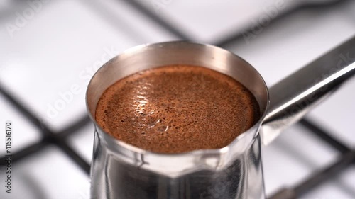 Boiling coffee while preparation in turkish coffee pot