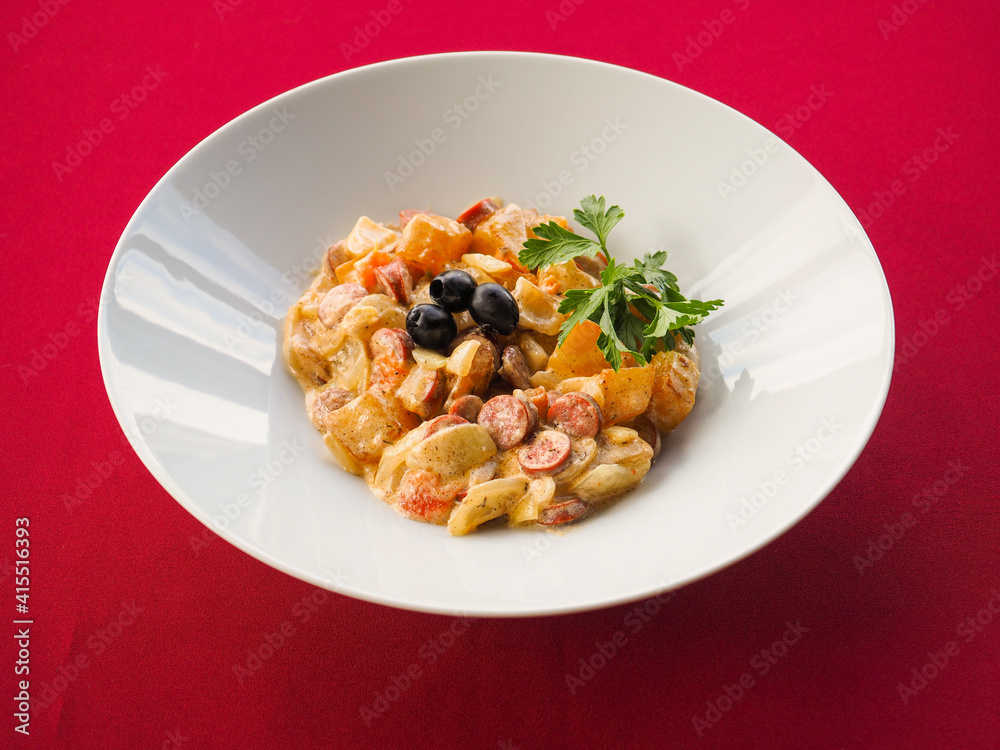 Sausage salad on red background Sausage salad on red background