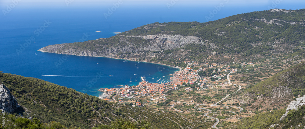 Panoramic view of Komiza town coastline from Mount Hum on Vis Island in Split Dalmatia region in Croatia
