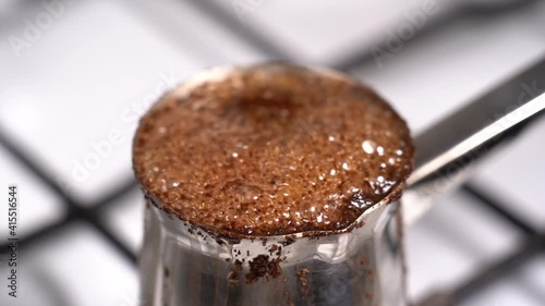 Boiling coffee while preparation in turkish coffee pot
