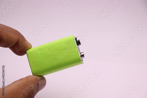 Alkaline battery or 9v battery with space for label held in hand photo