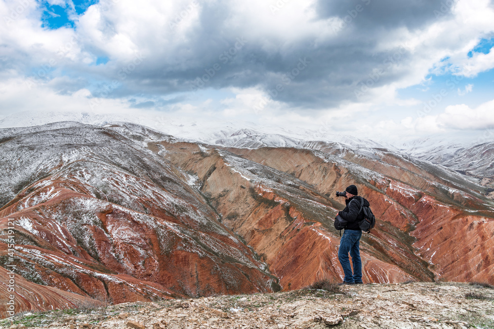 Nature photographer at mountain top take shoot of the landscape Nature photographer at mountain top take shoot of the landscape