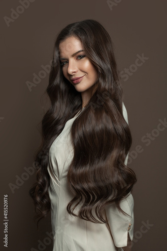 Healthy hair woman posing on brown background