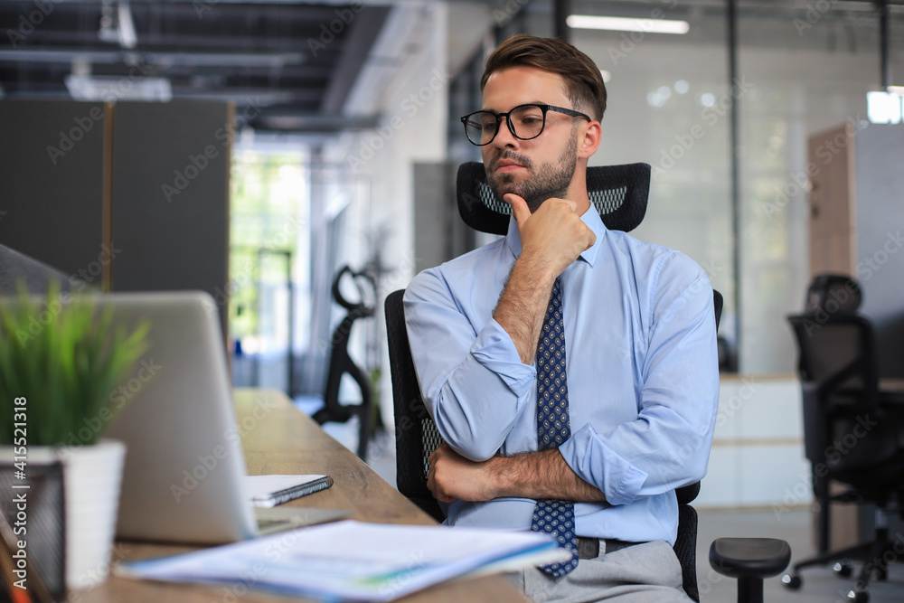Focused businessman thinking at modern office into report file calculating stock market earnings, startup business. Focused businessman thinking at modern office into report file calculating stock market earnings, startup business.