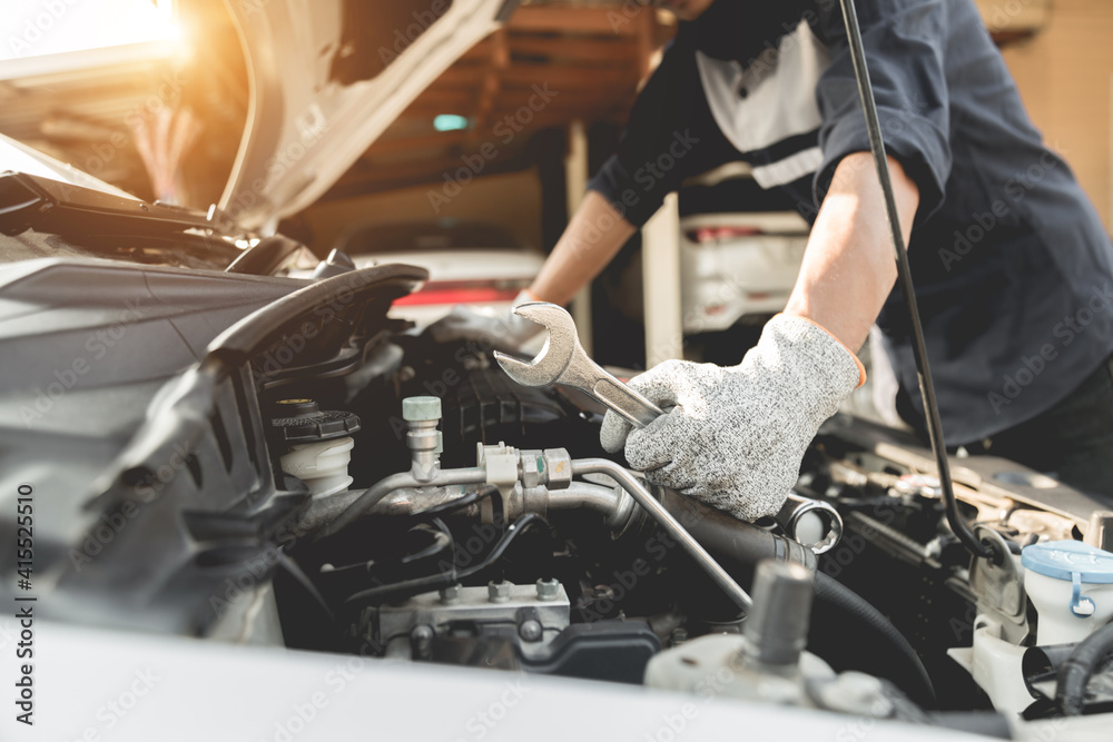 Automobile mechanic repairman hands repairing a car engine automotive workshop with a wrench, car service and maintenance,Repair service.
