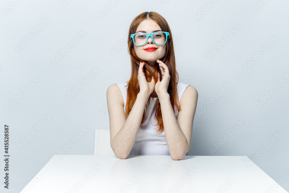 attractive red-haired woman in blue glasses with him at the table attractive red-haired woman in blue glasses with him at the table